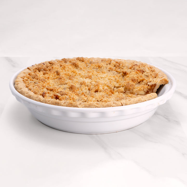11" Apple Crumb pie in white pie dish.