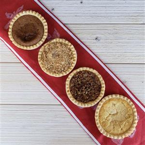 four assorted four inch pies